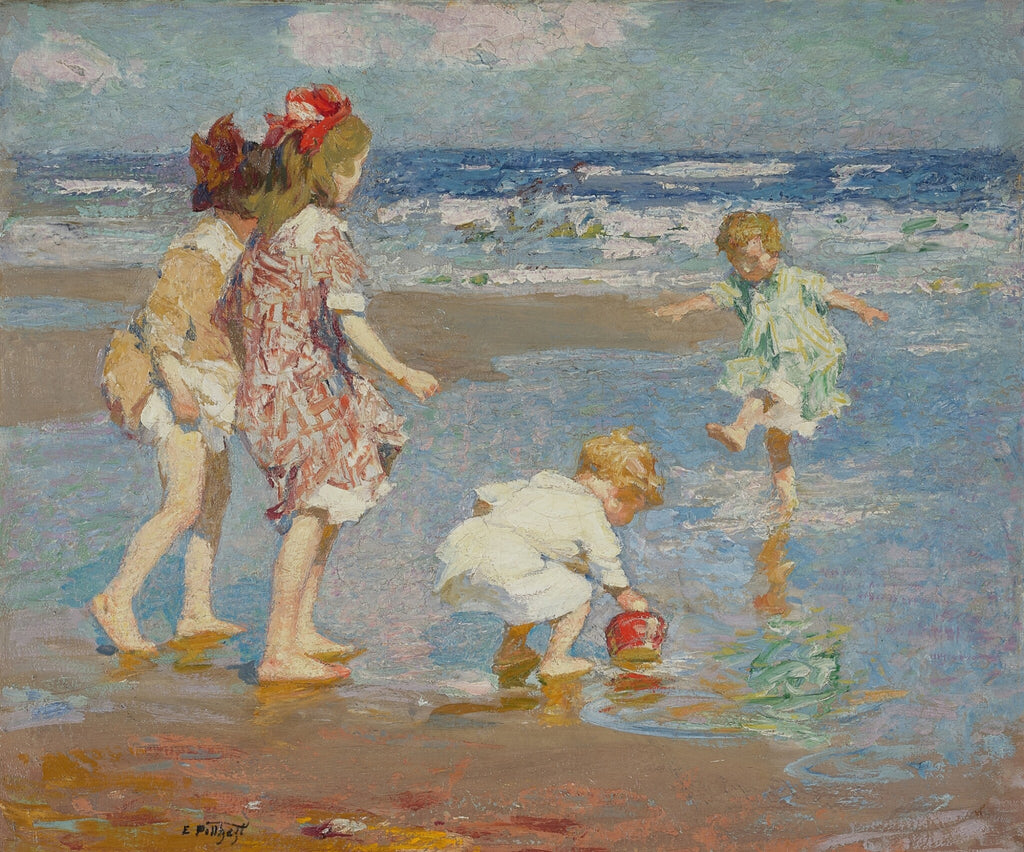 Children playing on a beach with ocean in the background