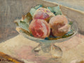 Impressionist oil painting of three pinkish-red peaches in a glass bowl with green leaves, signed E. V.