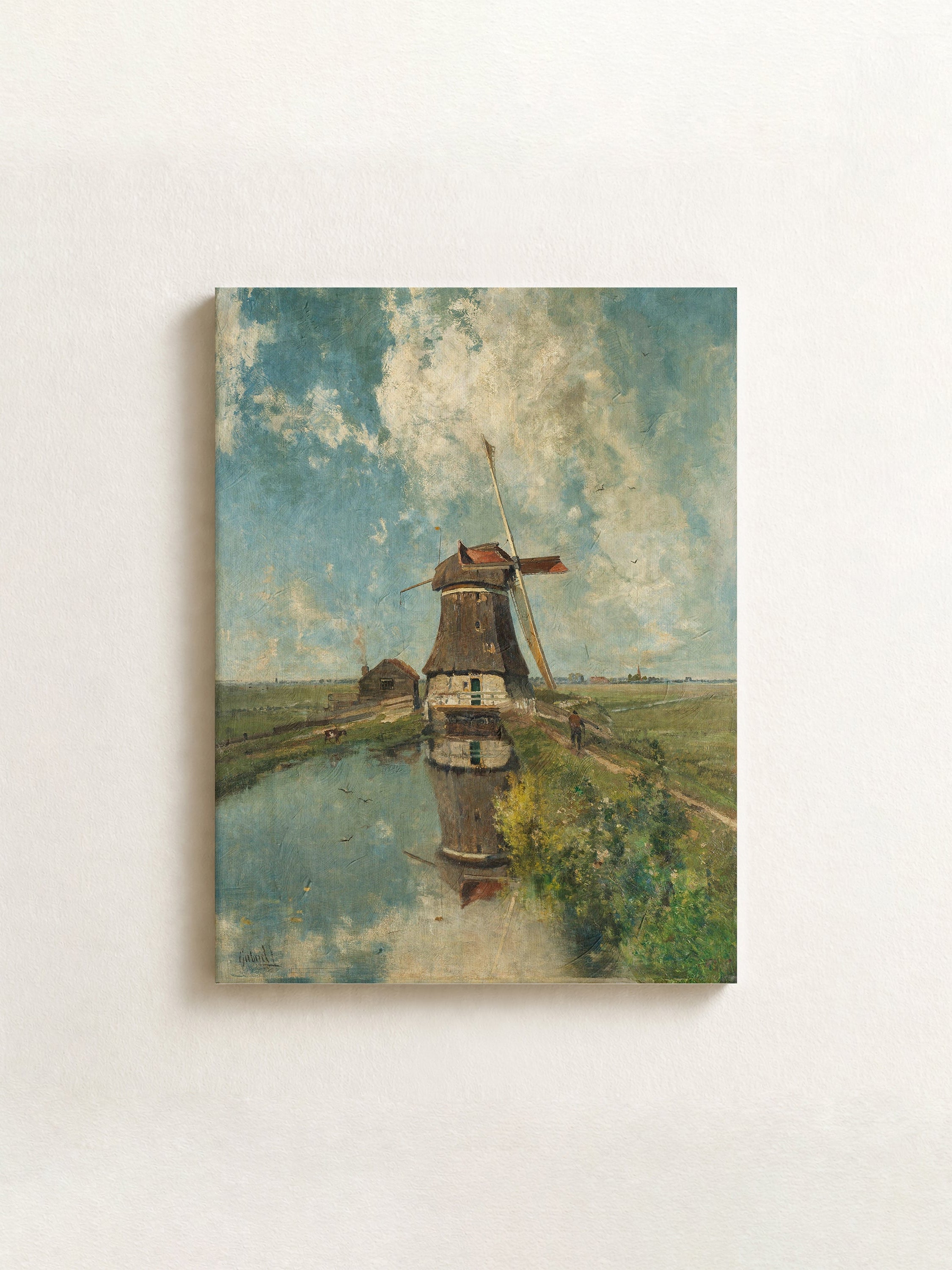 A horizontal canvas wall art print depicting an impressionistic landscape with a windmill, shown hanging on a textured off-white wall.