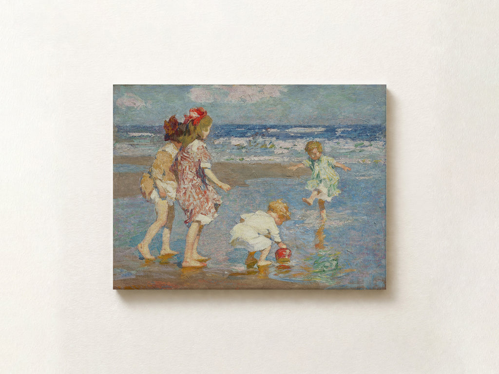 An impressionist-style painting of children playing on a beach, shown as a rectangular canvas mounted on a light beige wall.