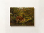 A rectangular canvas print of a classical landscape painting featuring a brown and white cow standing in a sunlit woodland stream, displayed on a textured off-white wall.