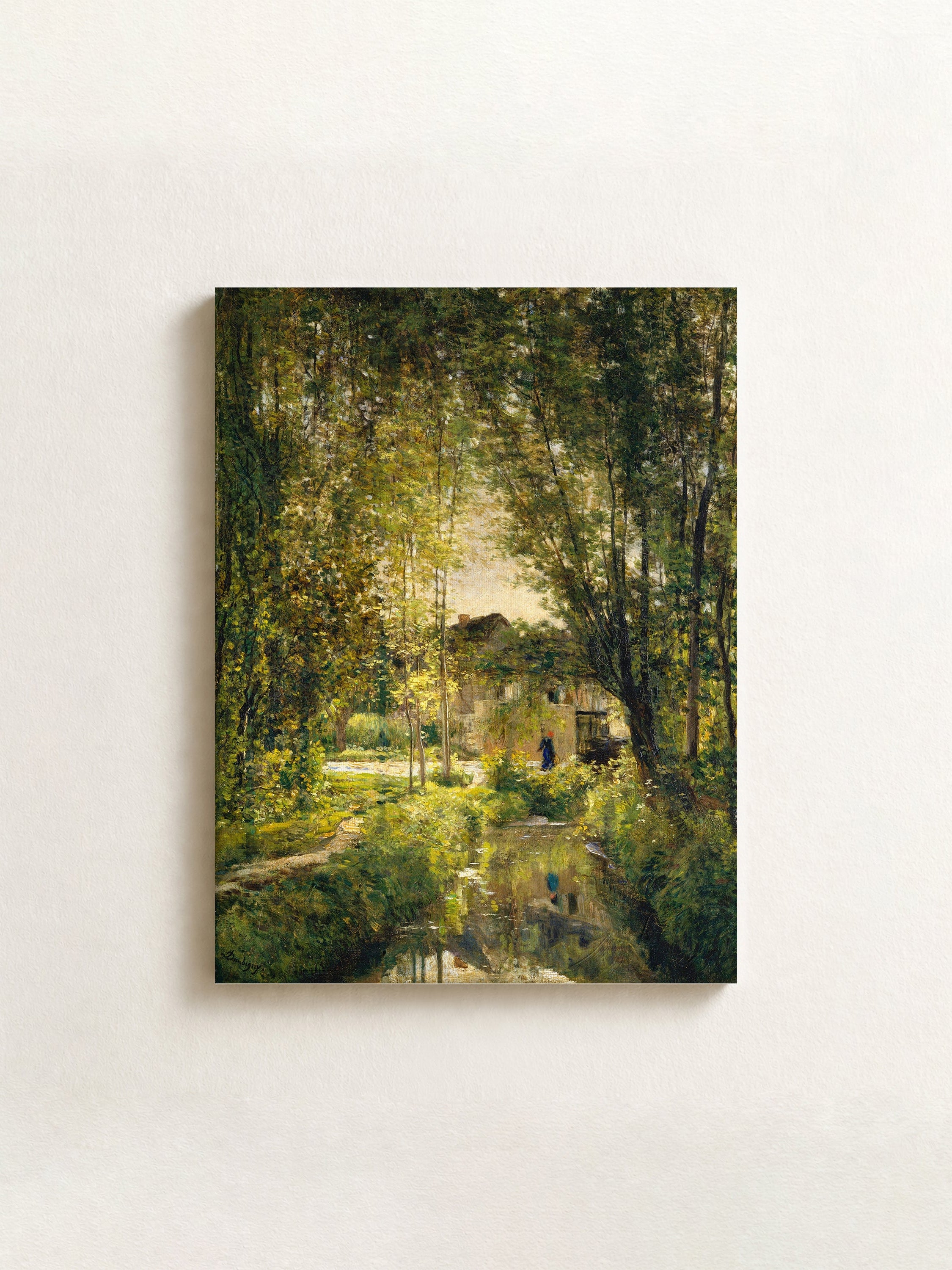 A horizontal canvas wall art print depicting an impressionistic green forest scene with trees and light filtering through foliage, mounted on a textured off-white wall.