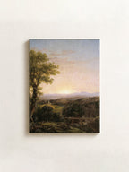 A vertical canvas print of a classical landscape painting featuring a tree, rolling hills, and a sunset, displayed on a textured off-white wall.