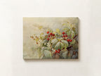A rectangular canvas wall art print featuring a botanical painting of red berries and green leaves on a soft beige background, displayed against a light textured wall.