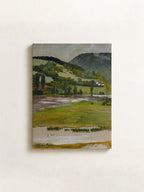 A horizontal landscape painting on canvas, depicting a green field, trees, and a winding path under a gray sky, mounted on a textured off-white wall.