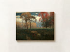 A horizontal landscape painting of an autumn field with trees in shades of red, orange, and green under a cloudy sky, displayed on a textured off-white wall.