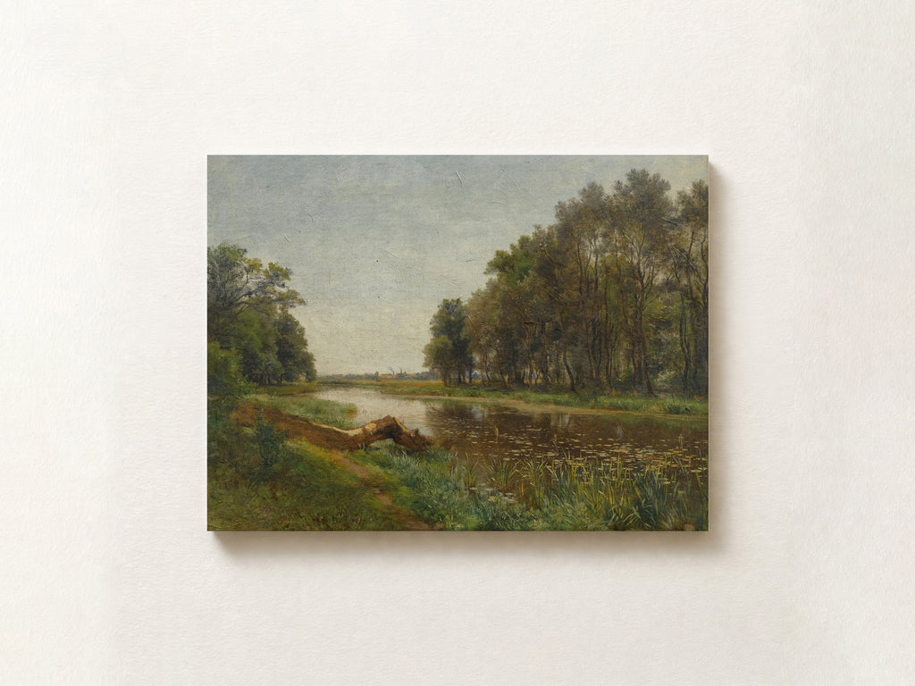 A horizontal landscape painting of a river with trees on the right bank and a grassy path in the foreground, shown hanging on a light beige wall.