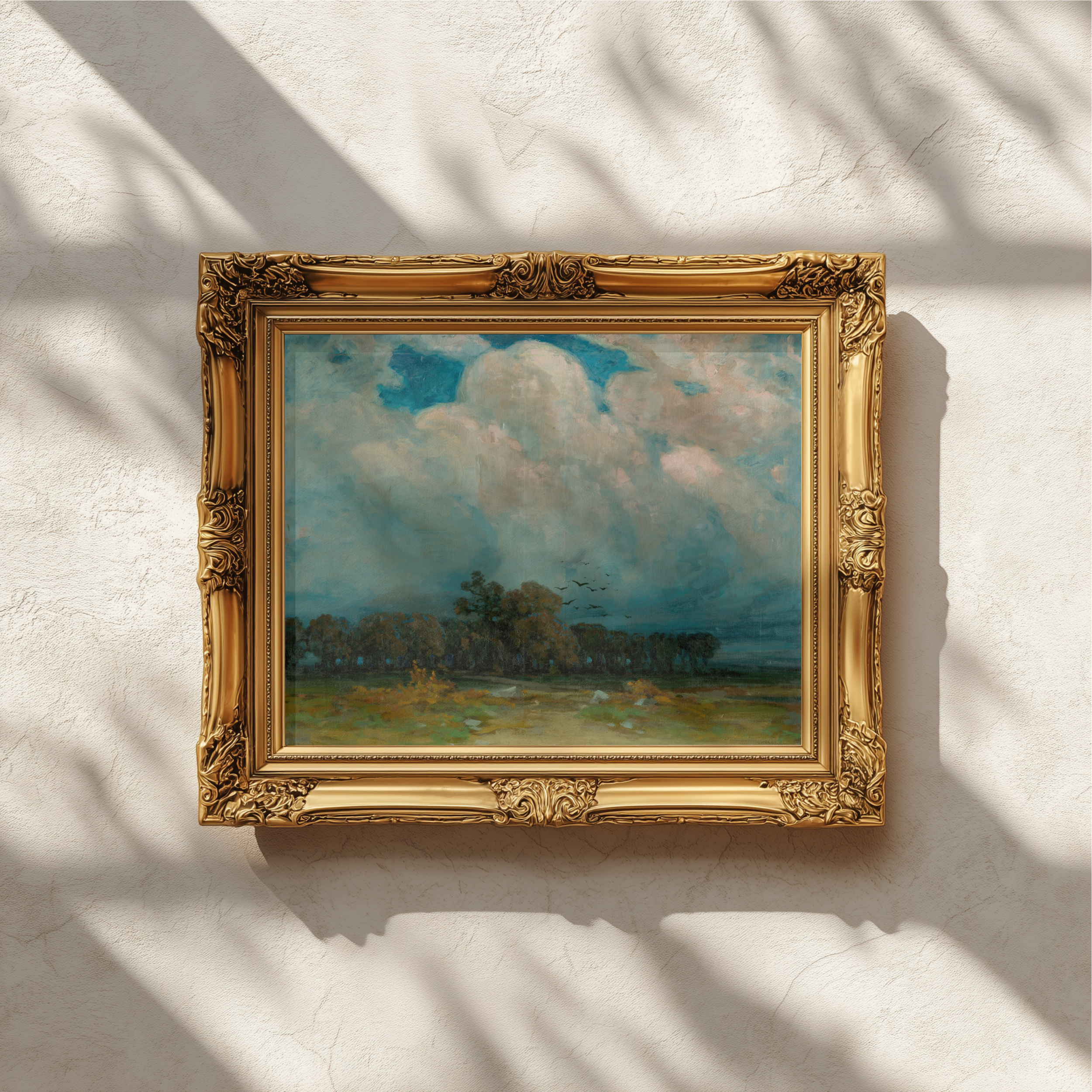 An ornate gold-framed landscape painting hanging on a textured white wall, with dappled sunlight and shadows cast across the frame and wall.