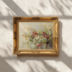 A framed botanical painting of red berries and green leaves, set in an ornate gold frame and mounted on a textured off-white wall with soft leaf shadows cast across it.