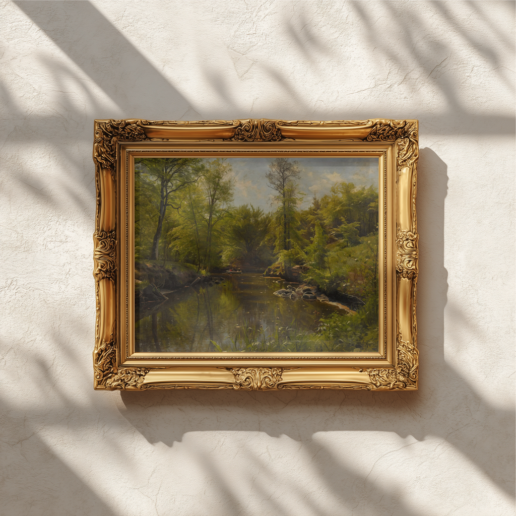 An ornate gold picture frame holding a landscape painting of a forest, mounted on a textured off-white wall with soft leaf shadows cast across it.