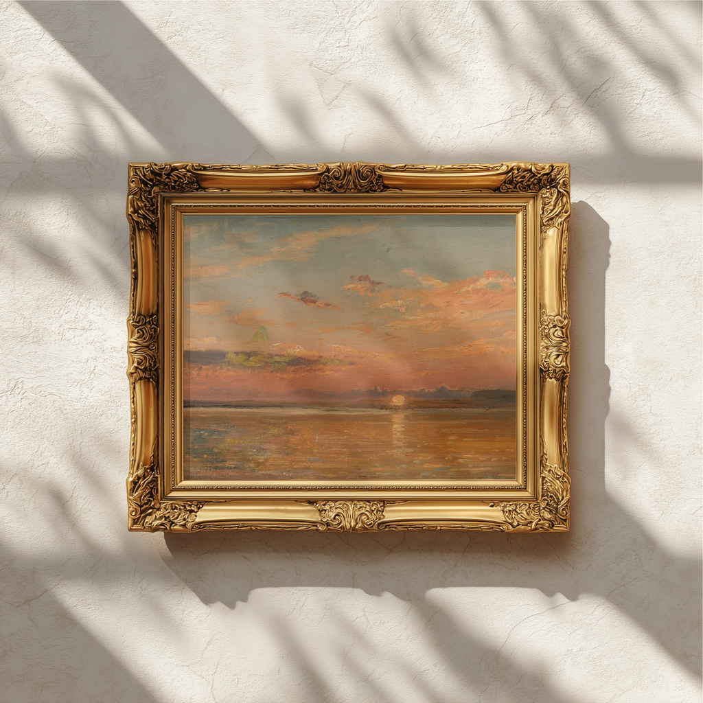 An ornate gold picture frame holding an abstract painting with warm orange, brown, and muted blue tones, mounted on a textured off-white wall with soft leaf shadows cast across it.