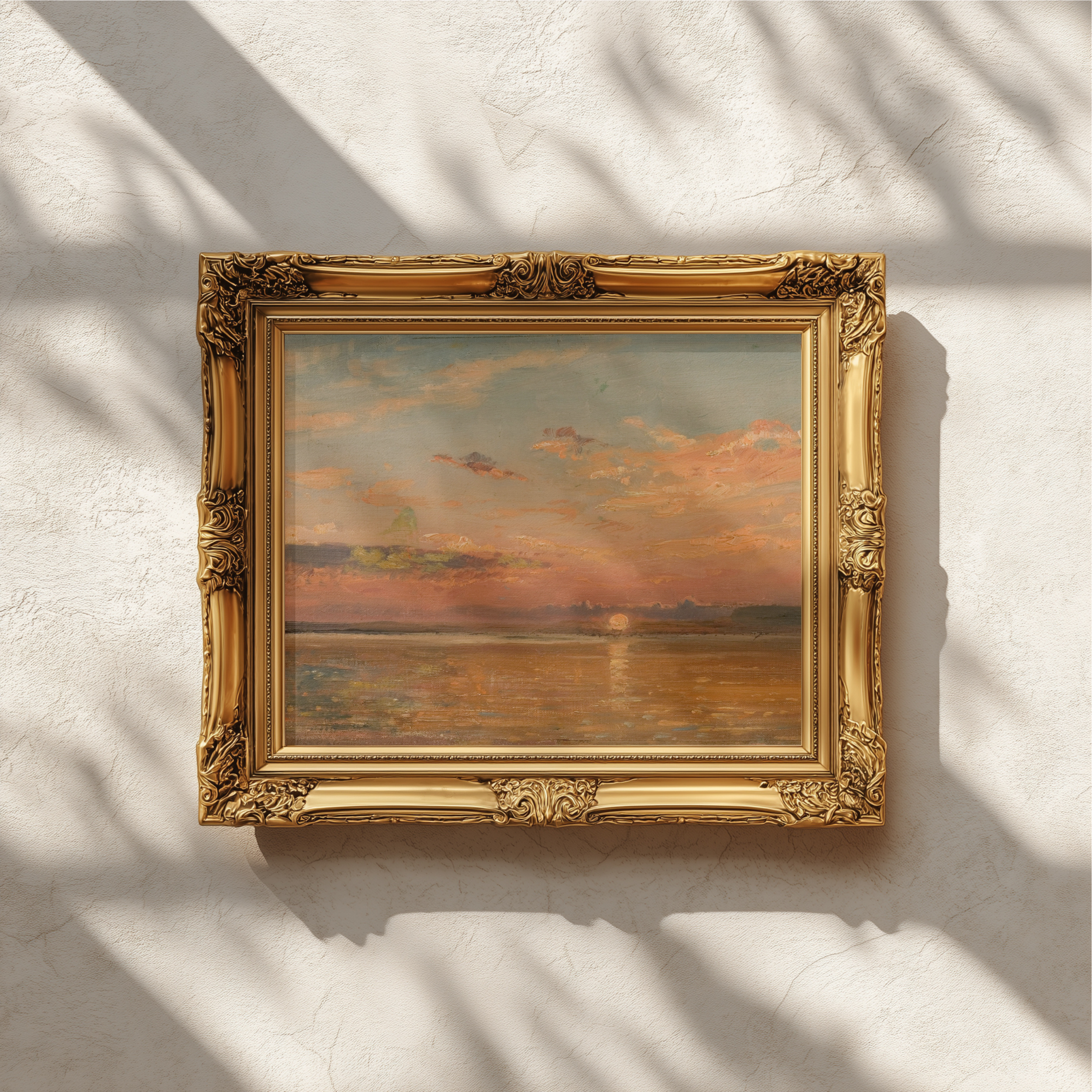 An ornate gold picture frame holding an abstract painting with warm orange, brown, and muted blue tones, mounted on a textured off-white wall with soft leaf shadows cast across it.