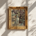 An ornate gold-framed painting of a white and tan dog sitting outdoors near trees, displayed on a textured off-white wall with soft leaf shadows cast across it.