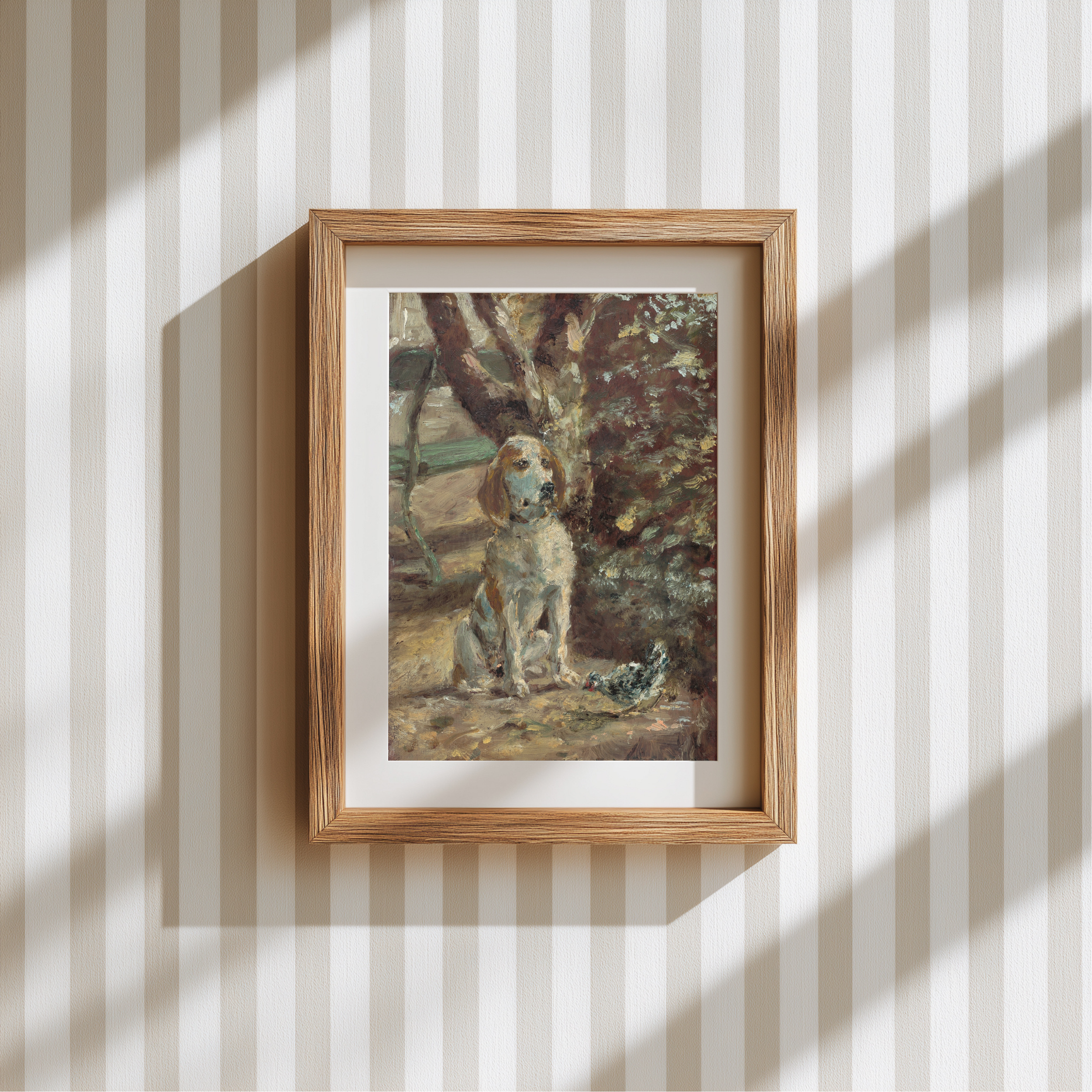 A framed art print depicting an impressionist-style painting of a white and brown dog sitting in a garden, mounted on a beige and white vertically striped wallpaper background with soft window shadow patterns.