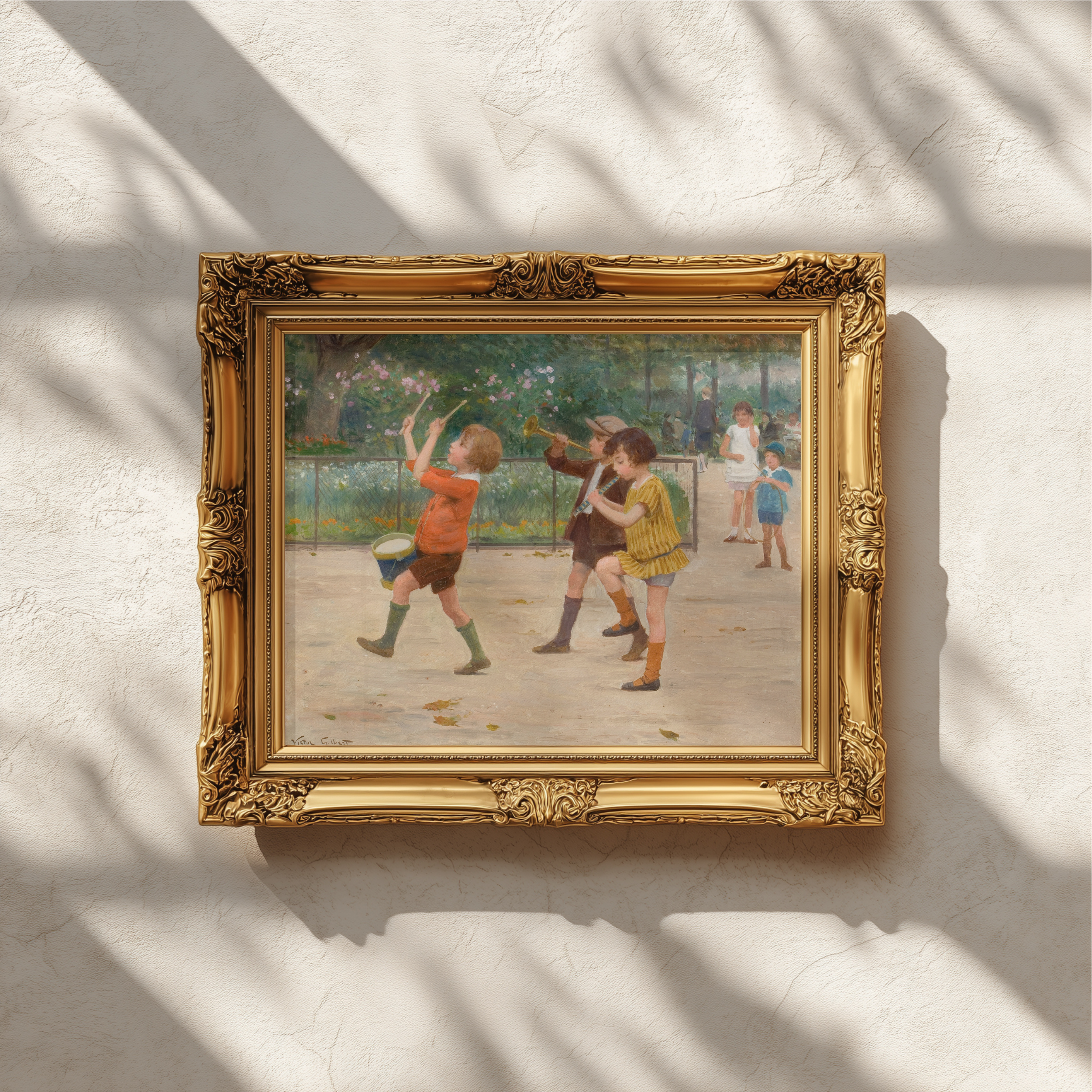 A framed vintage-style painting depicting children playing outdoors, mounted on a textured white wall with soft window shadows cast across it. The artwork is enclosed in an ornate gold frame.
