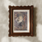 A framed art print depicting a classical religious scene with figures around a glowing body, mounted on a textured beige wall with soft shadows.