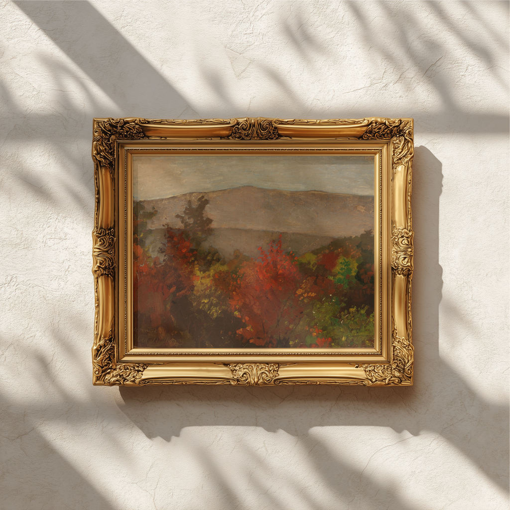 An ornate gold picture frame holding an impressionistic painting with red, green, and gray tones, mounted on a textured off-white wall with soft leaf shadows cast across it.