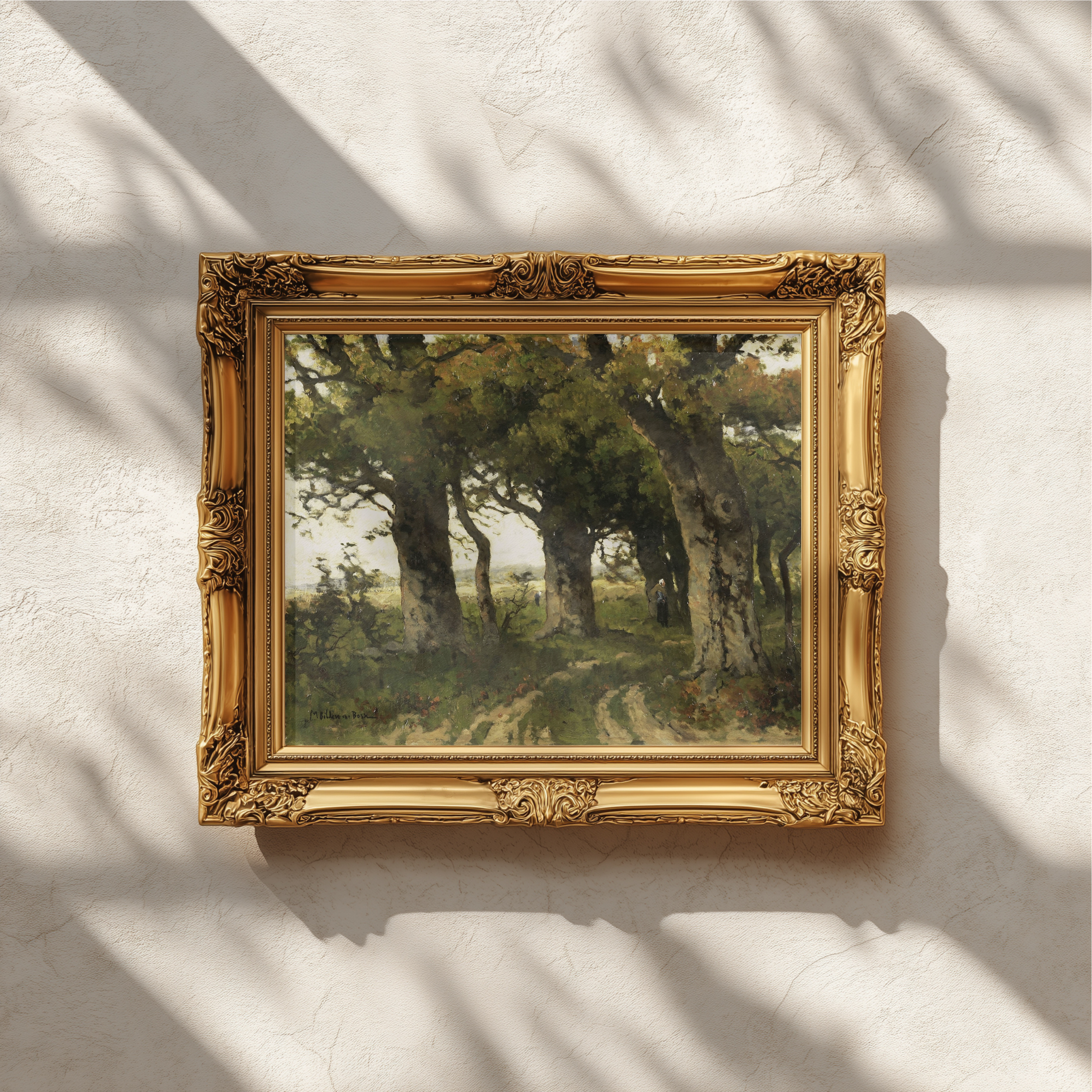 An ornate gold picture frame holding a landscape painting of a tree, mounted on a textured white wall with soft leaf shadows cast across it.