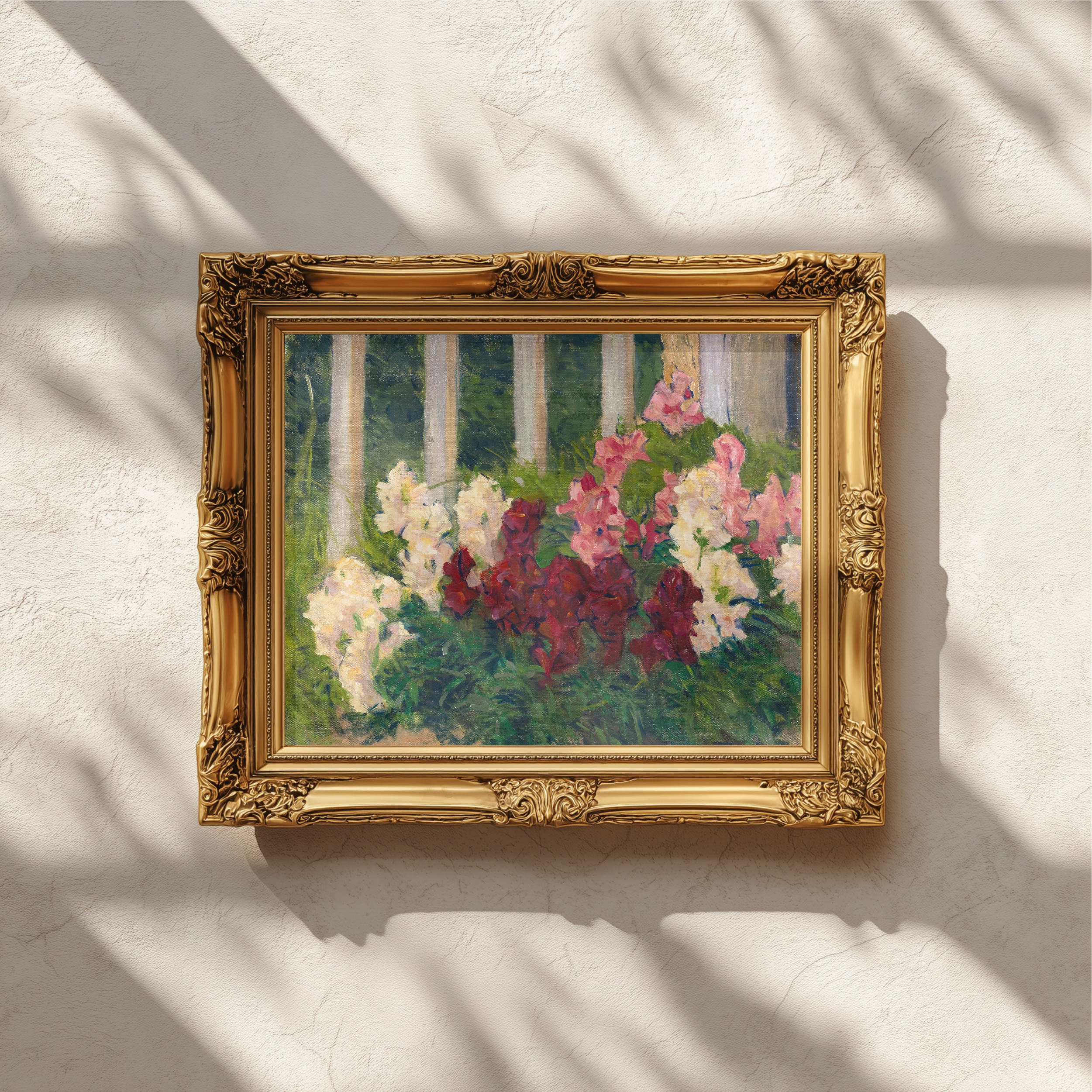 An ornate gold-framed painting of white, pink, and burgundy flowers against a green and white striped background, mounted on a textured off-white wall with soft window shadow patterns.