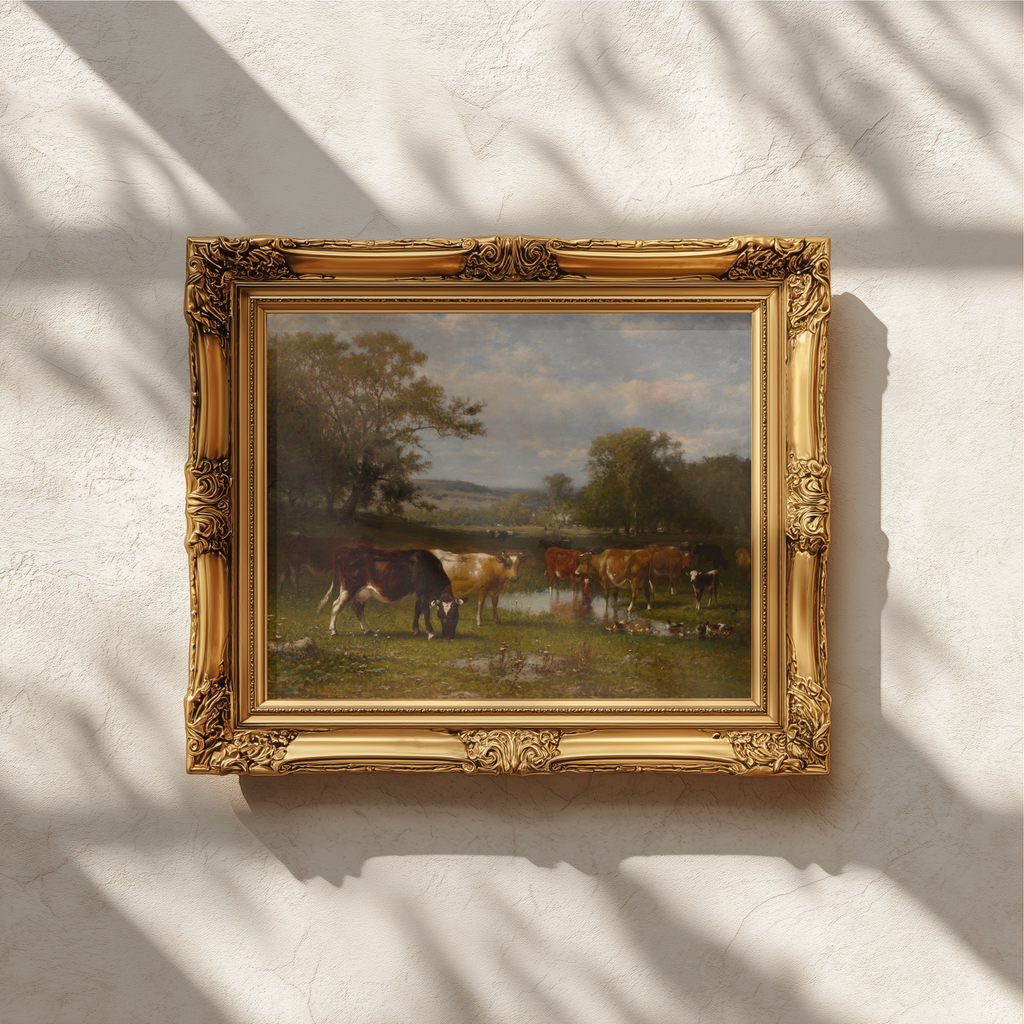 An ornate gold picture frame holding a landscape painting of horses by a river, mounted on a textured white wall with soft shadow patterns.