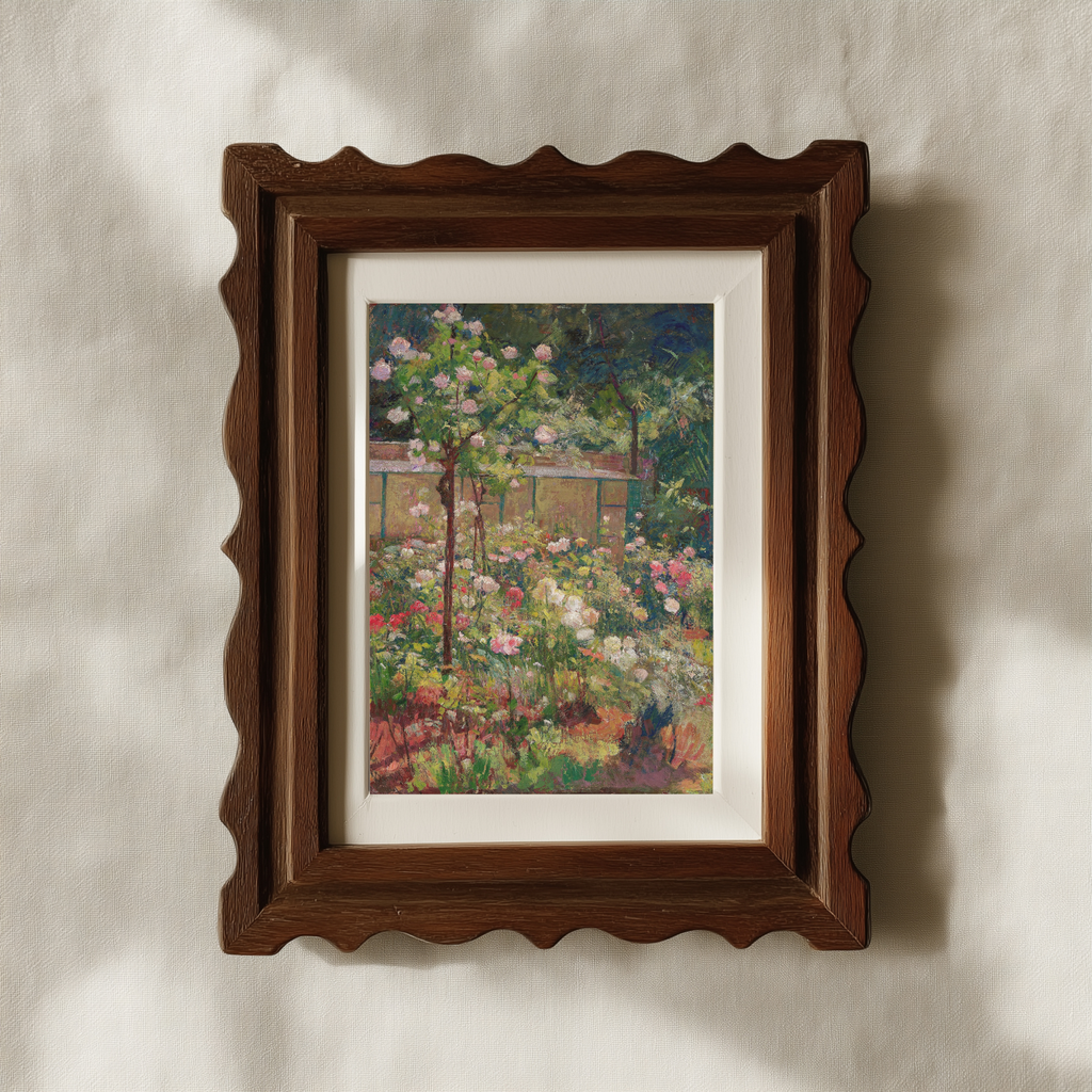A framed garden painting with a dark brown scalloped wooden frame and white matting, hanging on a textured beige wall with soft shadows.