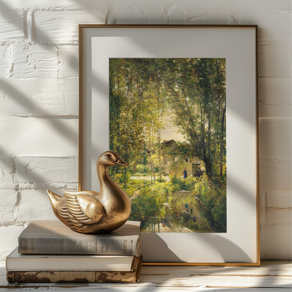 A framed art print depicting a lush green forest scene with a rustic cabin and pond, styled on a white brick wall next to a gold duck sculpture and books.