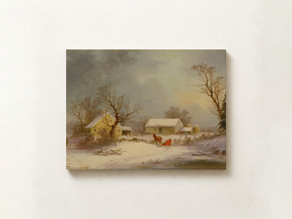 A framed-style canvas print of a winter landscape painting hanging on a light beige wall. The artwork depicts snow-covered farmhouses, bare trees, and a cloudy sky with a small red horse and cart near the center.